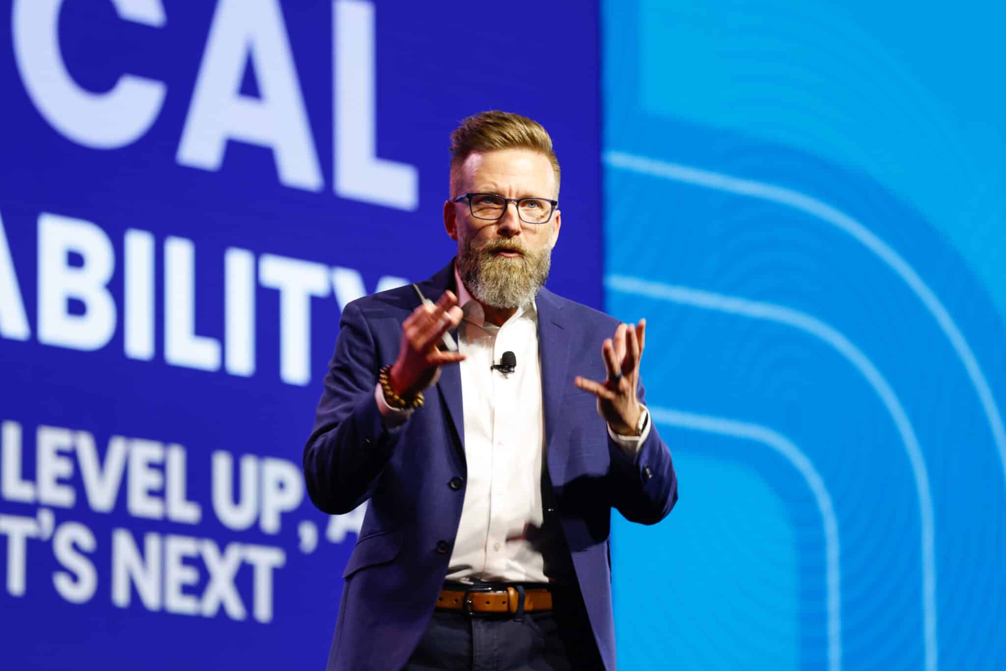 Shawn Ellis engaging an audience on stage during a Radical Adaptability keynote